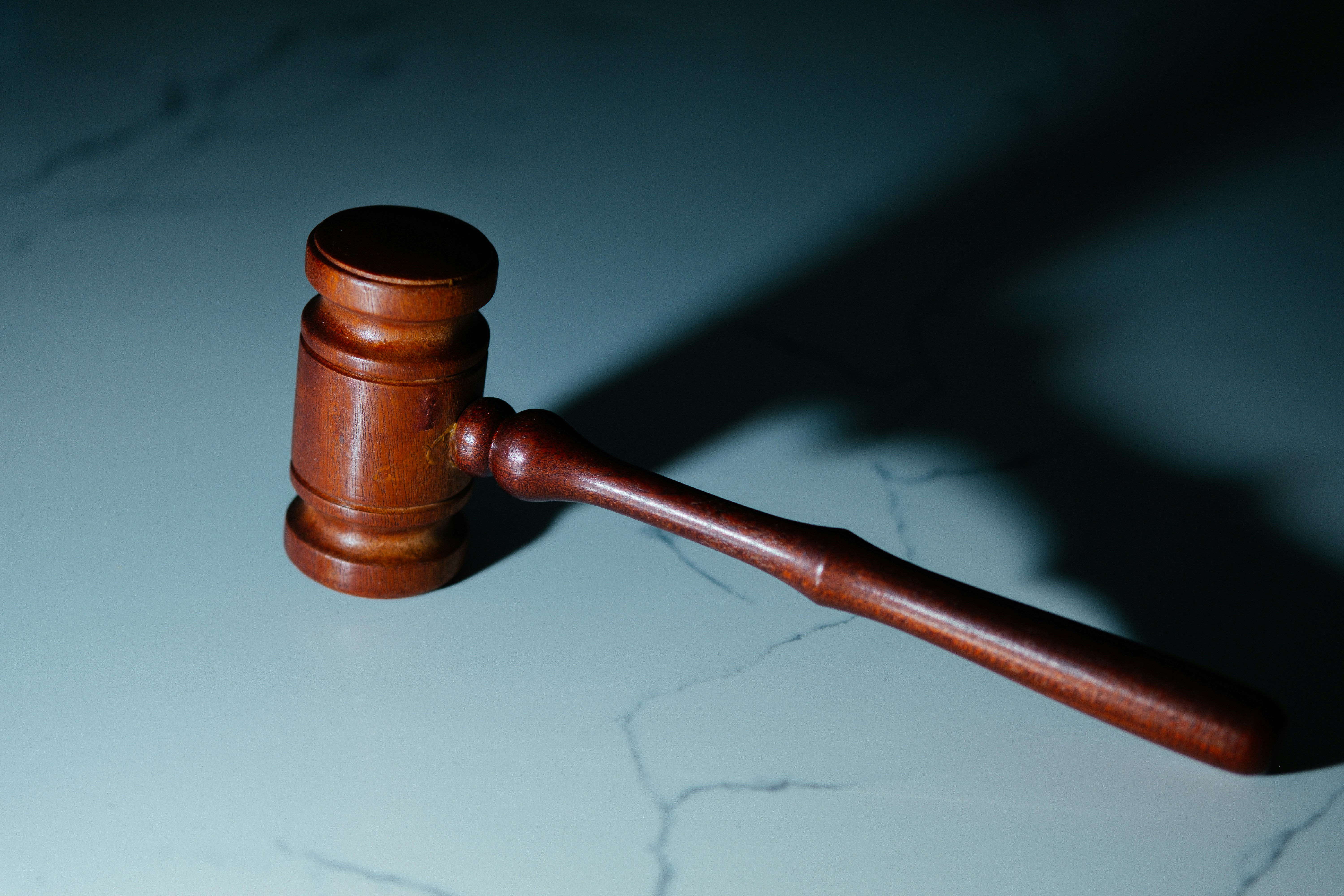 Gavel resting on a marble surface
