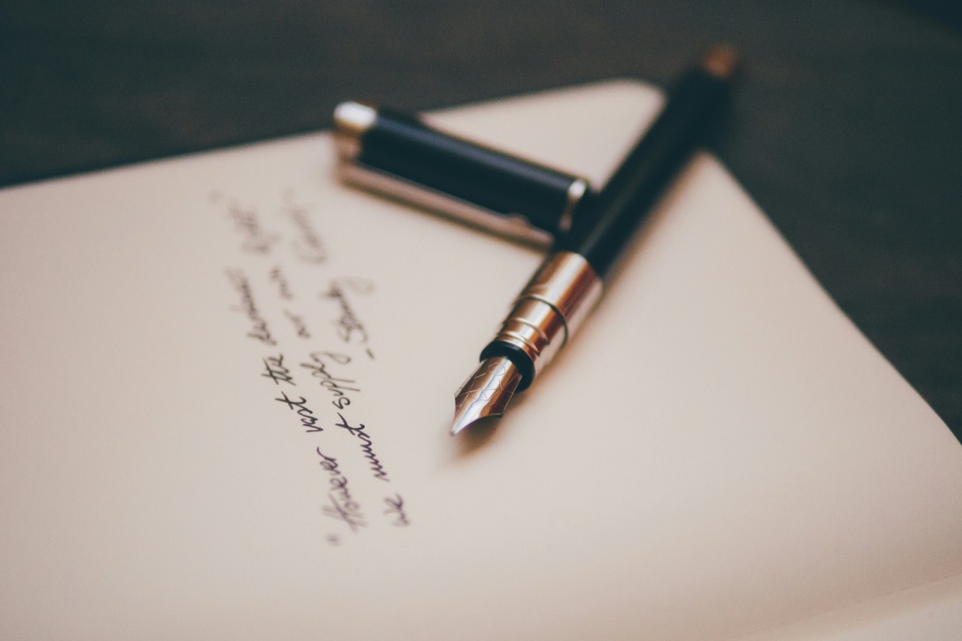 Fountain pen resting on a handwritten letter, symbolizing a firm, personal commitment